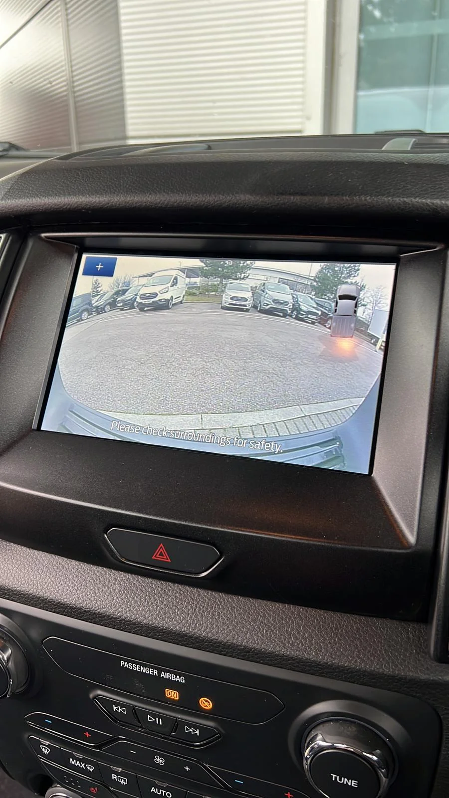 Dashboard monitor displaying a commercial vehicle reverse camera view