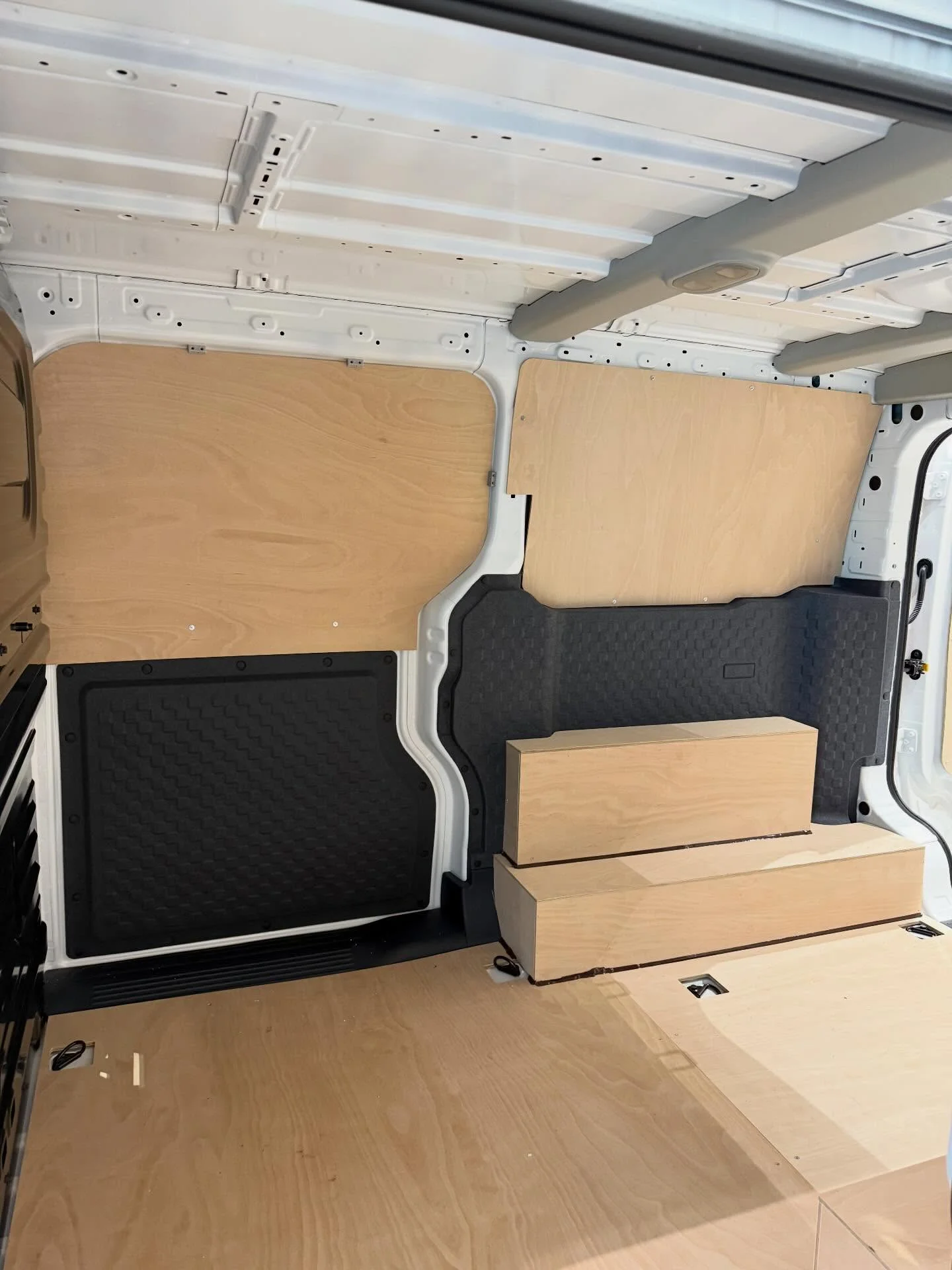 Protected walls, flooring and wheel arches inside a commercial van